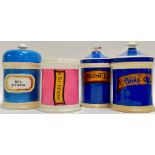 A group of four nineteenth century ceramic apothecary jars in blue and pink, variously labelled (Mel