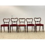 A set of five Victorian rosewood and mahogany balloon back dining chairs, with red velvet