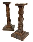 A pair of Edwardian Arts and Crafts style oak candle sticks, the rectangular tops raised in square