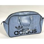 A Adidas vintage 1970's blue vinyl twin handled sports bag with zip closure to top and metal stud