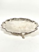 A Mappin & Webb George III style presentation silver card waiter with scalloped border and raised on