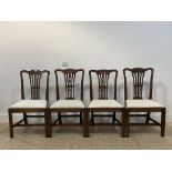A set of four Georgian mahogany dining chairs, with undulating crest rail above a pierced splat