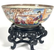 A Quing style Chinese Export Ware Famille Rose bowl on hardwood stand, with scenes of figures in