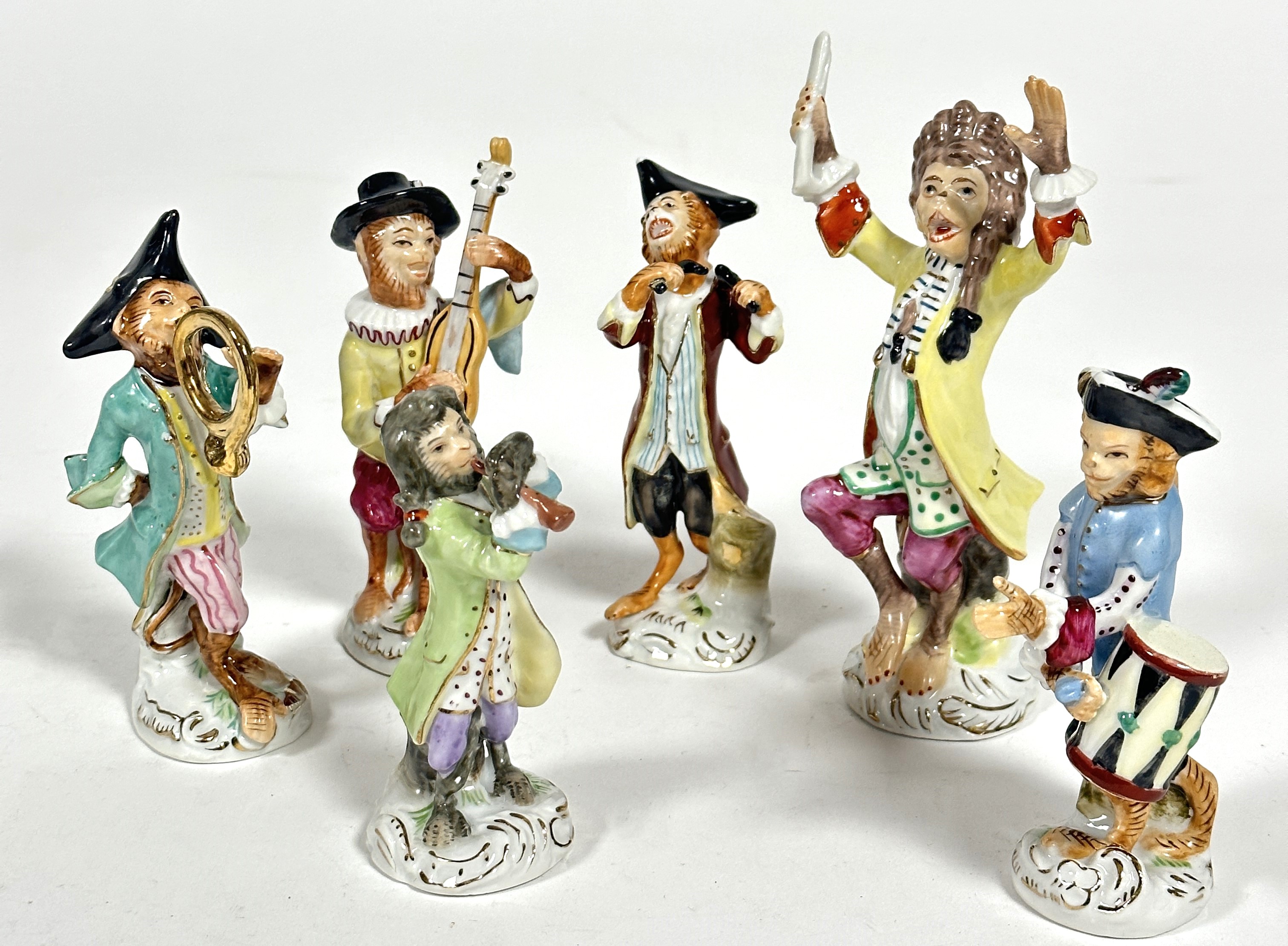 A 20thc porcelain Meissen style six piece Monkey band group of figures decorated with polychrome