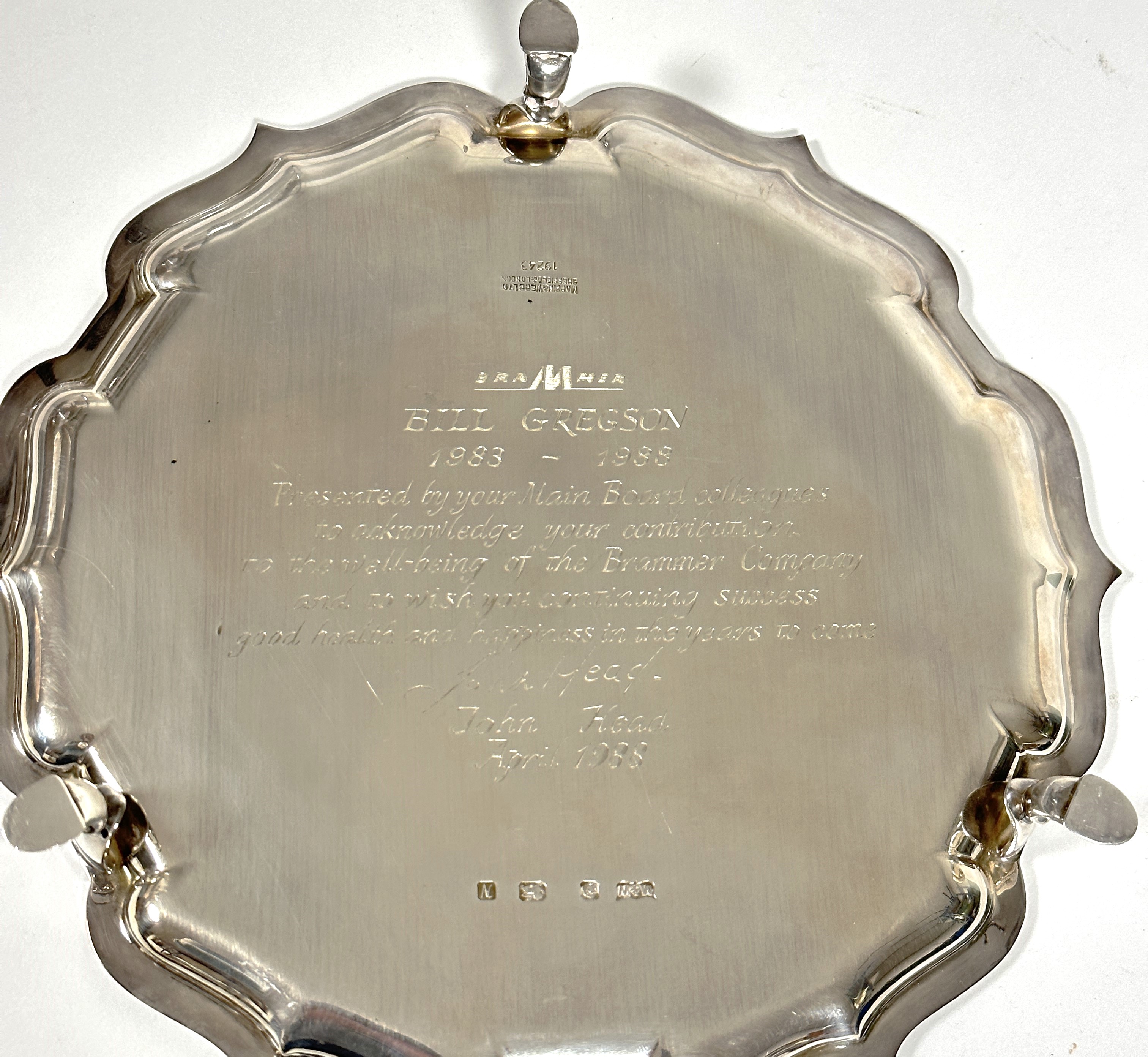 A Mappin & Webb George III style presentation silver card waiter with scalloped border and raised on - Image 2 of 2