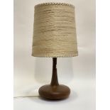A mid century turned teak lamp, of compressed ovoid form, the base stamped Modonell 1980, complete