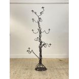 An impressive wrought iron floor standing candelabra of scrolling form H190cm