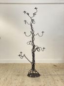 An impressive wrought iron floor standing candelabra of scrolling form H190cm
