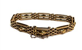 A Edwardian 15ct gold gate link bracelet with oval bead barrel central panels and safety chain, (D x
