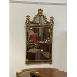 A gilt framed sectional wall mirror in the Baroque taste with palmette and acanthus motifs, 124cm