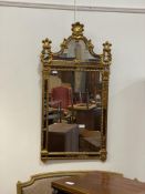 A gilt framed sectional wall mirror in the Baroque taste with palmette and acanthus motifs, 124cm