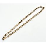 A late 19thc yellow metal fancy engraved oval link guard chain with lobster claw, (L x 47cm),