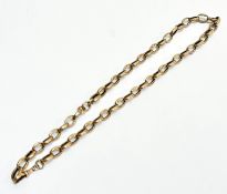 A late 19thc yellow metal fancy engraved oval link guard chain with lobster claw, (L x 47cm),