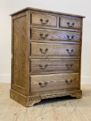 A tradiational elm and ash chest fitted with two short and four long graduated drawers, raised on