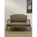 A Regency style gilt framed two seat settee, with upholstered back and seat, raised on turned,