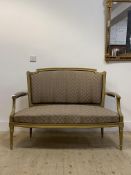 A Regency style gilt framed two seat settee, with upholstered back and seat, raised on turned,