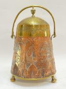 A brass and copper coal bucket with loop handle, decorated with embossed/repousse farm scene with