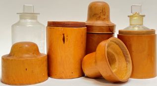 A group of three turned treen boxwoood bottle holders, two complete with glass jars (variously