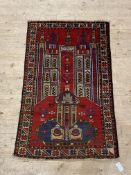 An old Baluchi rug, the red ground with mihrab, within a geometric border 130cm x 83cm