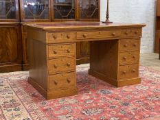 A late 19th / early 20th century oak twin pedestal desk, the top inset with tooled skiver, above one
