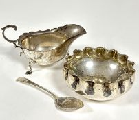 A Sheffield silver George III style sauce boat with scalloped top top and reverse C scroll handle