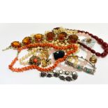 A collection of costume jewellery including a rose quartz beed necklace, coral bead and thong