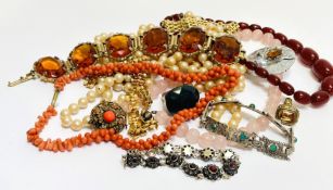 A collection of costume jewellery including a rose quartz beed necklace, coral bead and thong