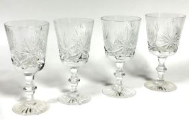 A set of four large slice cut crystal red wine glasses on knop stems and slice cut bases, (H x