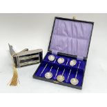 A boxed set of silver plated coffee spoons with purple coffee bean terminals (box l- 14cm, w- 15cm),