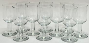 A set of 10 clear drinking glasses on with wide foot and stem (h- 13cm)