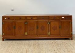 A large Chinese hardwood sideboard, fitted with six drawers and six panelled cupboard doors, all