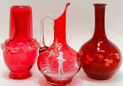 A group of Victorian cranberry/ruby glass comprising a globular bottle with engraved fruit and