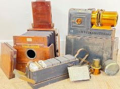 A magic lantern with boxes of glass slides and lenses, marks for Marion & Co etc...