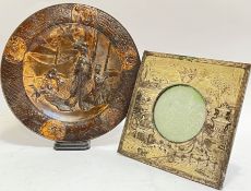 A Japanese Meiji style bronzed dish with scenes of ladies and dogs, the border decorated with