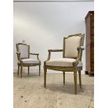 A pair of Regency style gilt framed arm chairs, with upholstered back and seat, raised on turned,