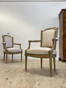 A pair of Regency style gilt framed arm chairs, with upholstered back and seat, raised on turned,
