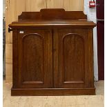 A Victorian mahogany ledge back side cabinet, fitted with two panelled doors, on a plinth base
