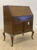 An early 20th century mahogany bureau, the cross banded fall front opening to a fitted interior,