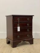 A Georgian style mahogany bedside chest, fitted with three drawers, raised on bracket supports