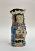 An early 19thc Prattware pottery Toby Jug with a figurative caryatid handle. (h-22cm) (repair and