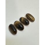 A pair of 9ct gold mounted Tigers Eye sleeve links of oval form, (L x 2cm), show no signs of repairs