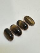 A pair of 9ct gold mounted Tigers Eye sleeve links of oval form, (L x 2cm), show no signs of repairs