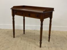 A Victorian mahogany side table, the galleried top above two frieze drawers, raised on turned