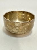 A Birmingham silver bowl with folded rim on plain foot, (H x 4.5cm x D x 9cm), slight bump to