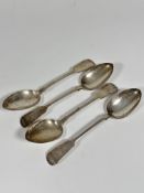 A set of four Victorian Newcastle silver fiddle pattern table spoons with engraved initials PM, (L x