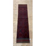 A Meshwani runner rug, decorated with eight lozenges 235cm x 59cm