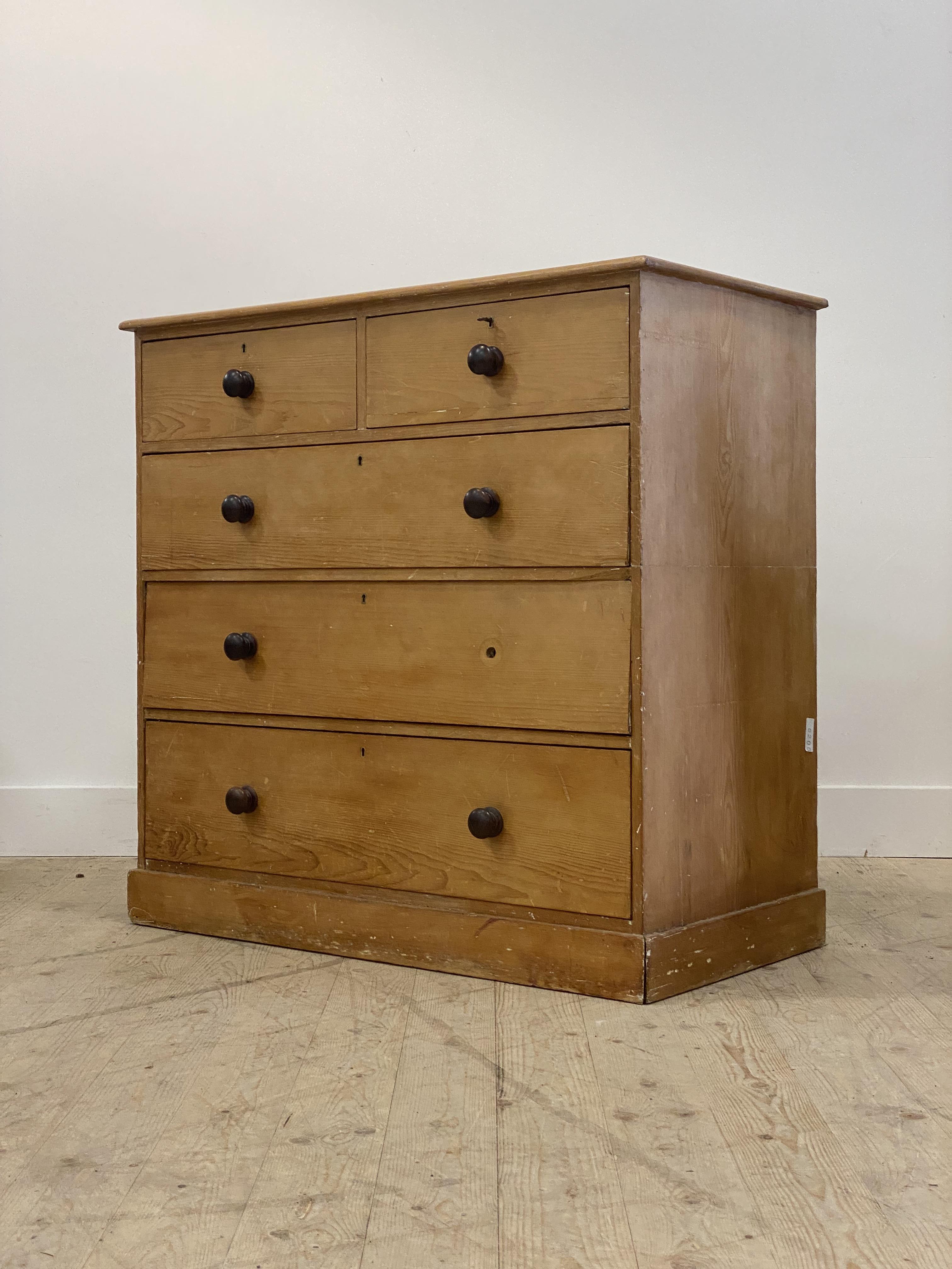 A Victorian stripped pine chest fitted with two short and three long drawers above a plinth base