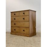 A Victorian stripped pine chest fitted with two short and three long drawers above a plinth base