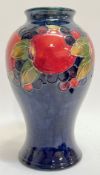 A 1920/30s Moorcroft pomegranate pattern baluster vase with dark blue ground (marked verso with W