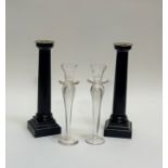 A pair of wooden black painted corinthian column style candle sticks (h-31.5cm) together with a pair